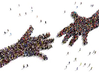 1031004_largegroupofpeopleseenfromabovegatheredtogetherintheshapeoftwohandsreachingouteachother_463515