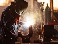 industrial worker at the factory welding
