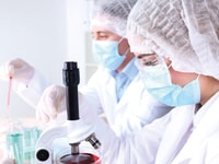 Spec-gases-Laboratory-Male-and-female-scientists-using-microscope-in-laboratory