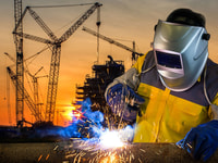 welder working a welding metal with protective