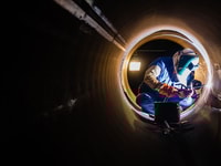 workers welding pipeline