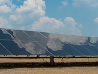 Clouds reflected in solar panel at Air Products