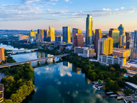Austin Texas USA sunrise skyline cityscape over Town Lake or Lady Bird Lake with amazing reflection. Skyscrapers and Texas capital building in distance you can see the entire city during summer
