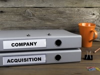 Company and Acquisition - two folders on wooden office desk