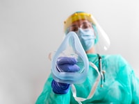 Doctor Woman holds Oxygen Mask for Inhale breath problem Patient, Coronavirus or Covid19 attack Lungs