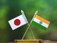 India and Japan small flag with blur green background