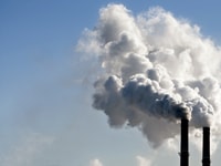 industrial smoke from chimney on blue sky