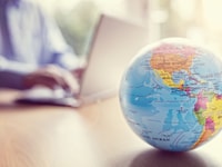 North America-businessman-using-a-laptop-with-globe