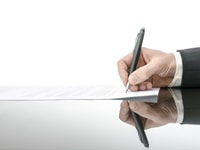 Signing a contract on a black table. With copy space and reflection_129508757