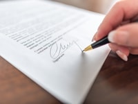 Woman hand signing a contract_310318895