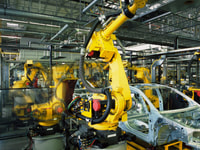 manufacturing-yellow-robots-welding-cars-in-a-production-line
