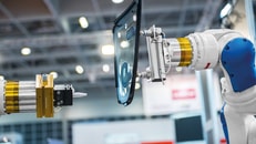 industrial automated robot arm holding car glass in factory