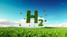 Eco friendly clean hydrogen energy concept. 3d rendering of hydrogen icon on fresh spring meadow with blue sky in background_1092687374