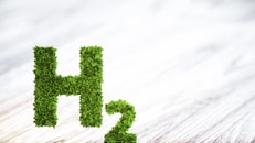 Green hydrogen element sign on blurred wooden background. 3D illustration_591927398