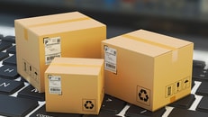 stock Internet shopping, online purchase, e-commerce and packages delivery concept, merchandise cardboard boxes on laptop keyboard_RGB PP