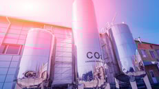 The tank with water, carbon and ladder. Equipment for beverages factory. Background