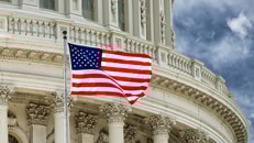 Washington DC Capitol dome detail with waving american flag