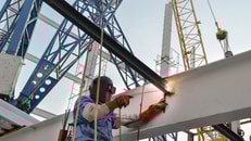 welder-with-protective-mask-welding-metal-and-sparks