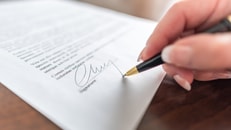Woman hand signing a contract_310318895