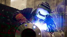 worker-with-protective-mask-welding-metal-and-sparks