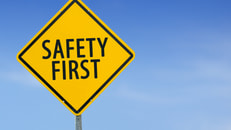 Yellow traffic sign-Safety First-on the sky background