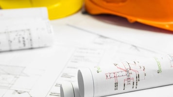 Compliance-Architectural-blueprint-of-office-building-with-a-pencils
