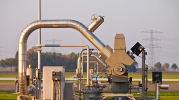 Modern natural gas well detail during sunset
