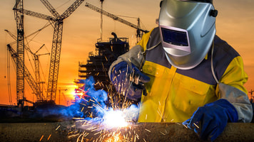 welder working a welding metal with protective
