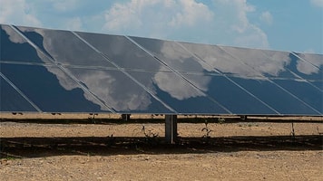 Clouds reflected in solar panel at Air Products