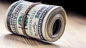 Close-up rolled American dollars banknotes_555861163