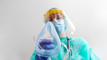 Doctor Woman holds Oxygen Mask for Inhale breath problem Patient, Coronavirus or Covid19 attack Lungs