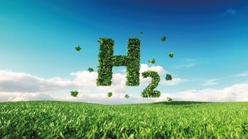 Eco friendly clean hydrogen energy concept. 3d rendering of hydrogen icon on fresh spring meadow with blue sky in background_1092687374