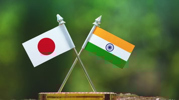 India and Japan small flag with blur green background