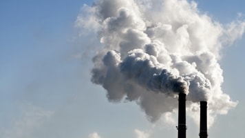industrial smoke from chimney on blue sky