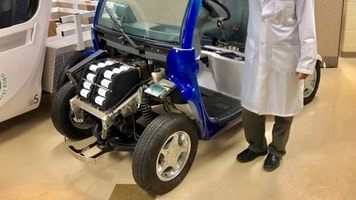Xianguo Li with fuel cell test vehicle