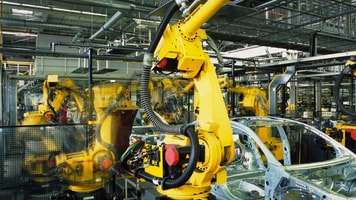 manufacturing-yellow-robots-welding-cars-in-a-production-line