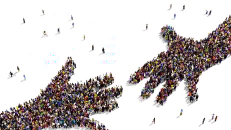 1031004_largegroupofpeopleseenfromabovegatheredtogetherintheshapeoftwohandsreachingouteachother_463515