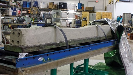 concrete sleepers loaded onto curing system base