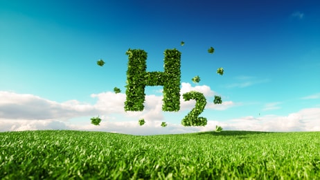 Eco friendly clean hydrogen energy concept. 3d rendering of hydrogen icon on fresh spring meadow with blue sky in background_1092687374