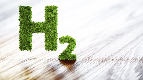 Green hydrogen element sign on blurred wooden background. 3D illustration_591927398