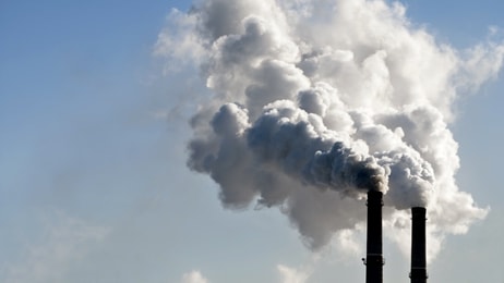 industrial smoke from chimney on blue sky