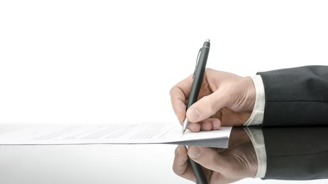 Signing a contract on a black table. With copy space and reflection_129508757