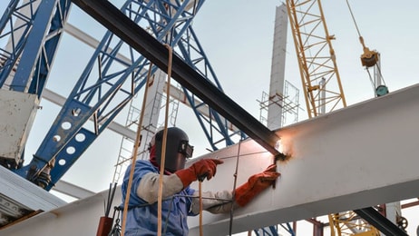 welder-with-protective-mask-welding-metal-and-sparks