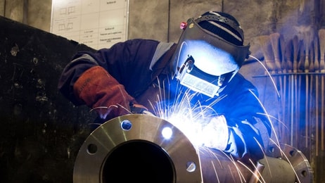 worker-with-protective-mask-welding-metal-and-sparks